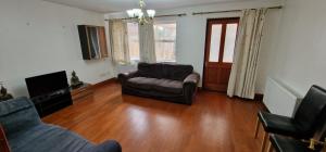 a living room with a couch and a chair at Grafton House in Martlesham