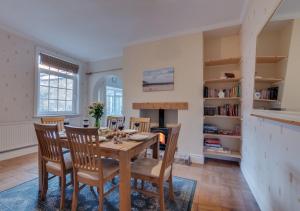 a dining room with a table and chairs and a fireplace at Mews Cottage in Scarborough