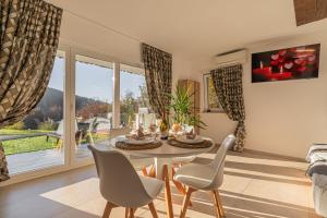 a dining room with a table and chairs and a window at Wellness Resort Trebnje in Trebnje