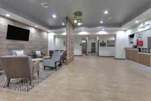 a lobby with a waiting area with chairs and a tv at Candlewood Suites Lake Jackson, an IHG Hotel in Lake Jackson