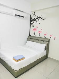 a bedroom with a bed with pink flamingos on the wall at FREE WIFI-FI Travelers HomestySitiawan 5-8pax The Venus Aparment in Seri Manjung