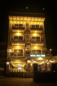 a tall building with lights on it at night at Hotel Eco Tree Pokhara in Pokhara