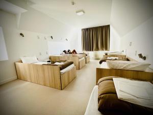 a room with four beds in a room at La Brasserie Hostel in Metz