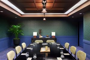 a dining room with a long table and chairs at The Jay, Autograph Collection in San Francisco