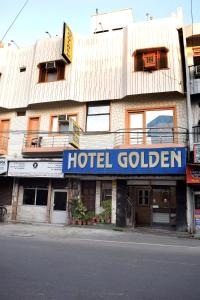 a hotel golden sign on the front of a building at Hotel Golden in Haridwār