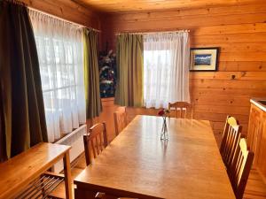 a dining room with a wooden table and a christmas tree at Alpine ski chalet Borovets with sauna in Borovets