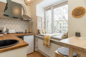 a kitchen with a sink and a window at Studio in the heart of Pärnu, free parking! in Pärnu