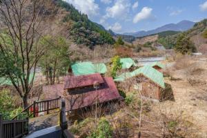 a group of buildings in a field with a river at Mori no Kuni - Vacation STAY 03842v in Ōma