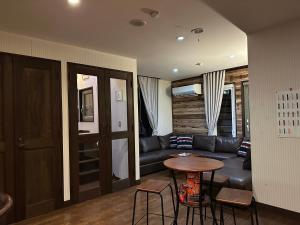 a living room with a couch and a table at Legend Inn Myoko in Myoko