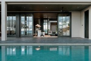 an external view of a house with a swimming pool at The Six in Midigama East