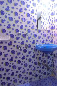 a bathroom with a sink and a blue and white tiles at Ocean View Cottage in Calangute