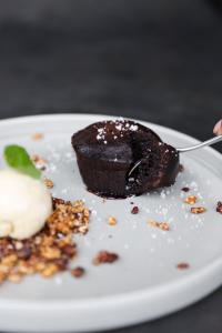 a piece of chocolate dessert on a plate with a spoon at Wasabi in Canggu