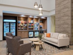 a lobby with a couch and chairs and a table at Candlewood Suites - Birmingham - Inverness, an IHG Hotel in Birmingham