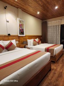 a hotel room with two beds in a room at SaPa Retreat Condotel in Sa Pa