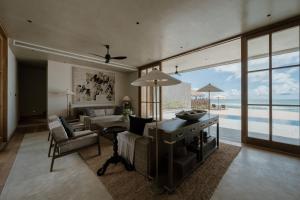 a living room with a view of the ocean at The Six in Midigama East