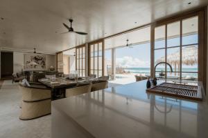 a kitchen and living room with a view of the ocean at The Six in Midigama East