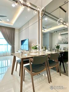 a dining room with a table and chairs at Melaka Ong Kim Wee Residences by Stayrene in Melaka