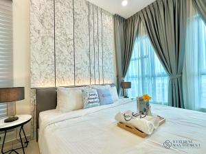 a bedroom with a large white bed with a window at Melaka Ong Kim Wee Residences by Stayrene in Melaka