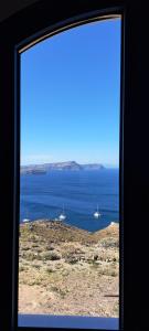 a view of the ocean from a window at Caldera Heights Apartment in Akrotiri