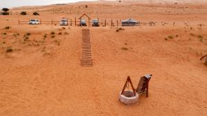 a model of a desert with a bridge in the sand at Sand Delight Camp in Al Wāşil