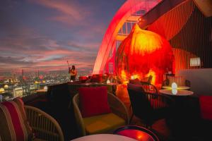 a restaurant with a fire pit on top of a building at Centara Grand At CentralWorld in Bangkok