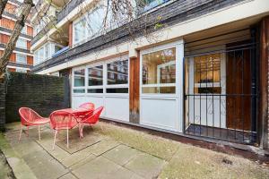 a table and chairs in front of a building at The Kennington Park Crib - Lovely 2BDR Flat with Garden in London