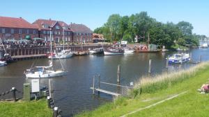 a group of boats are docked in a river at Balkonwohnung Roter Sand in Hooksiel