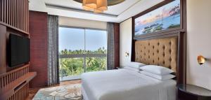 a bedroom with a bed and a large window at Sheraton Kosgoda Turtle Beach Resort in Bentota +140 photos