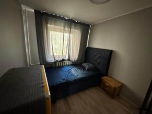 a small room with a bed and a window at Tihase Vindi Accommodation in Tallinn