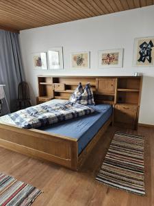 a bedroom with a large bed with a wooden headboard at Ferienhaus Birnberg in Leogang