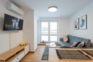 a living room with a couch and a tv at Vip Apartamenty Niecia z klimatyzacja in Rzeszów