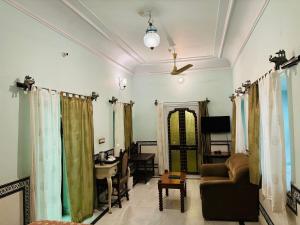 a living room with a couch and a desk at Saba Haveli in Jaipur