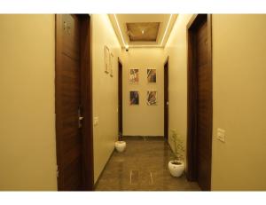 a hallway with two potted plants in a room at The Royal Casa Hotel, Ludhiana in Ludhiana