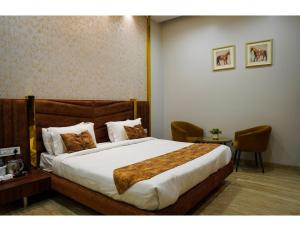 a bedroom with a large bed in a room at The Royal Casa Hotel, Ludhiana in Ludhiana