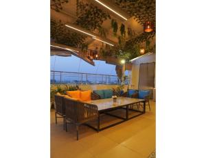 a dining room with a table and chairs and a balcony at The Royal Casa Hotel, Ludhiana in Ludhiana