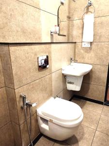 a bathroom with a toilet and a sink at Tea & Sky Munnar in Munnar