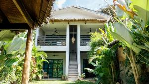 a house in the middle of a garden at El Nido Boutique Vacation Villas in El Nido