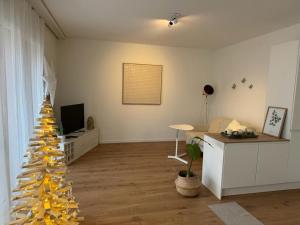 a living room with a christmas tree in a room at Appartement calme et lumineux de 2,5 pces proche Lausanne in Ecublens