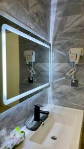 a bathroom with a sink and a mirror at Wooden House on lake,city center in Luang Prabang