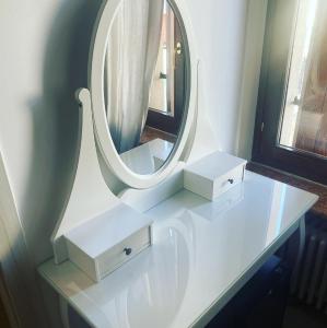 a white sink with a mirror on top of it at Cinema Rooms Fiera Verona in Verona