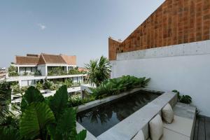 a view from the balcony of a building with a swimming pool at The Komu in Canggu