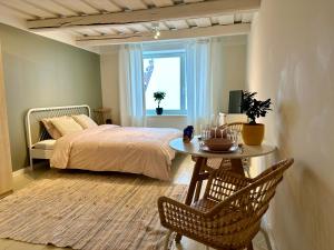 a bedroom with a bed and a table with chairs at Romantic hideout with parking in Viljandi