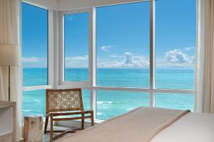 a bedroom with a window view of the ocean at Oceanfront Private Condo at 1 Hotel & Homes -1219 in Miami Beach