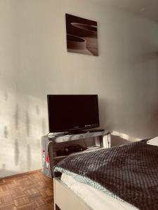 a bedroom with a bed and a flat screen tv at STUDIO APP STELLA Dnevni najam stana Jarun Zagreb in Zagreb