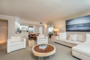 a living room with white furniture and a table at Oceanview Private Condo at 1 Hotel & Homes -915 in Miami Beach