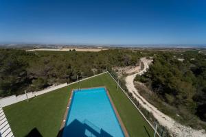 an overhead view of a swimming pool in a field at Royal Sunset close to Golf fields in San Miguel de Salinas