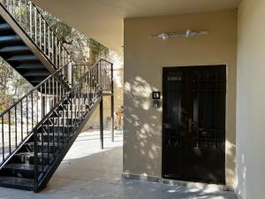 a black door and stairs next to a building at Downtown Inn Madaba in Madaba