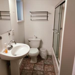 a white bathroom with a toilet and a sink at Fancy SF Suite, Prime Location, Near Fishermans Wharf, SF Bay and Financial District in San Francisco