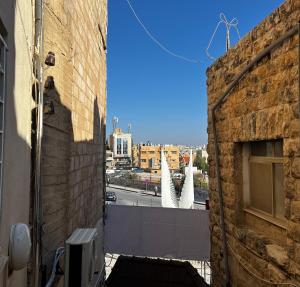 a view of a city from a brick building at Downtown Inn Madaba in Madaba