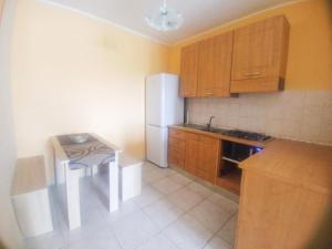 een keuken met een witte koelkast en een tafel bij Residenza ColleMare Vacanze in Colonnella